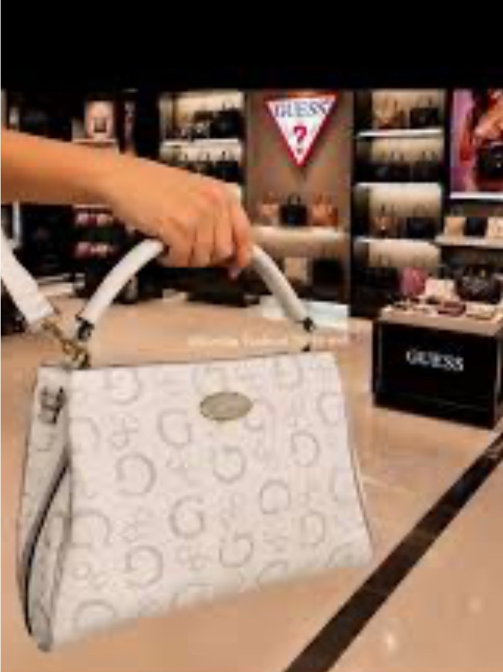 Guess Oakbank satchel features an elegant bone white base with a repeating